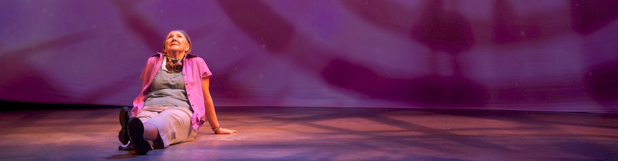 Susinn McFarlen in Burning Mom, 2025; set design by Patrick Rizzotti; costume design by Kirsten McGhie; lighting design by John Webber; projection design by Kim Clegg; photo by Moonrider Productions for the Arts Club Theatre Company