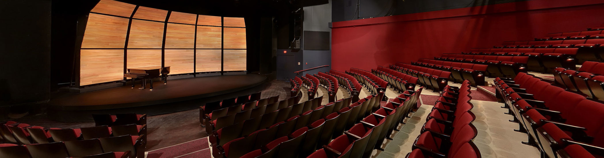 Photo of the Granville Island Stage interior. Onstage there is a grand piano and the room is empty.