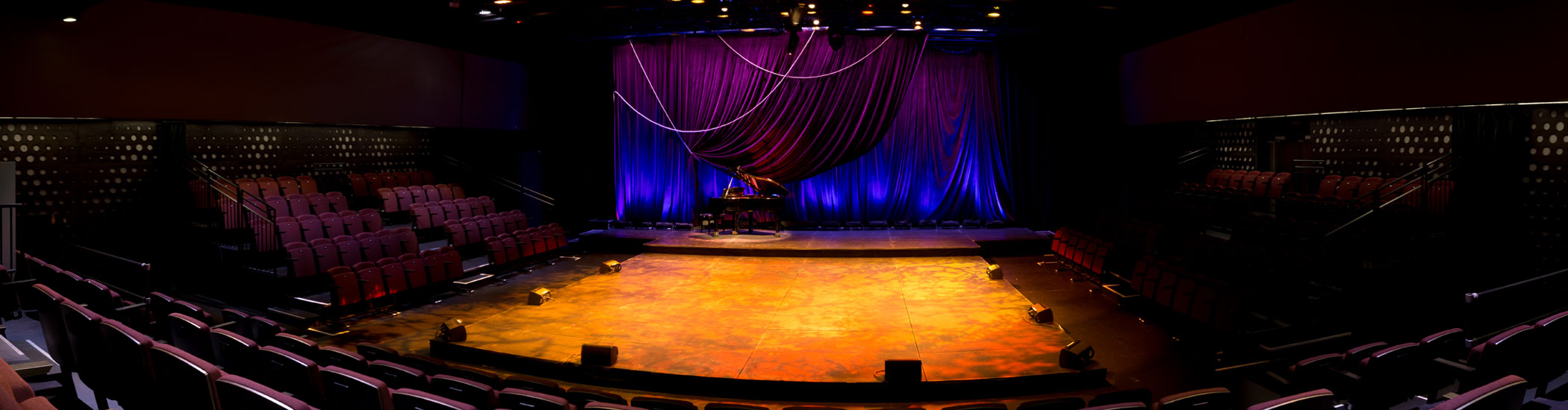 Photo of the Newmont Stage at the BMO theatre Centre interior. Onstage is a piano and the room is empty.