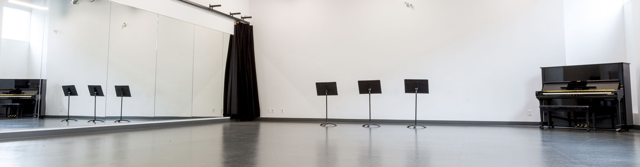 Photo of a bright empty rehearsal studio.